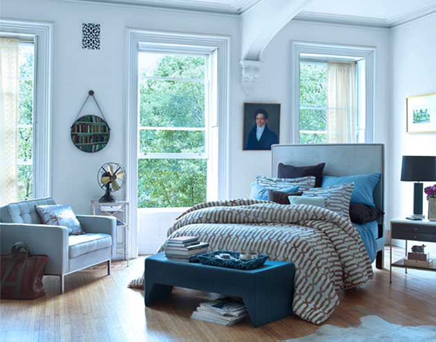 bedroom with poster bed and many Nate Berkus pillows and throws