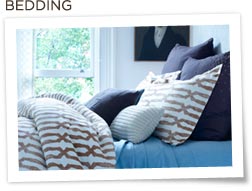 Nate Berkus bedding and pillows on bed
