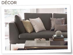 Nate Berkus throw pillows on couch with coffee table and books in front